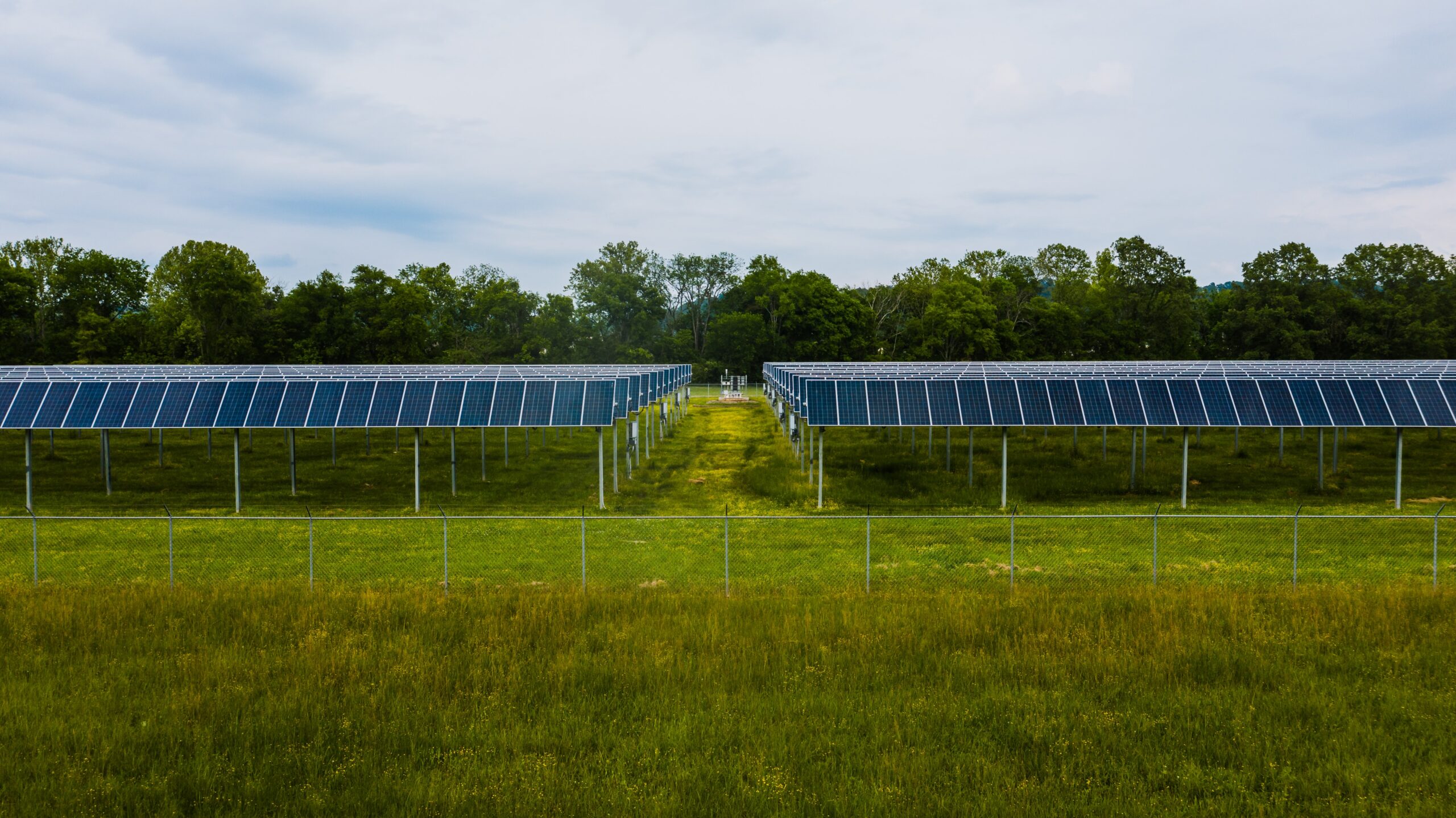 An array of solar panels in a grassy field meant to symbolize how independent community solar can help Indiana move toward a healthier, cleaner future