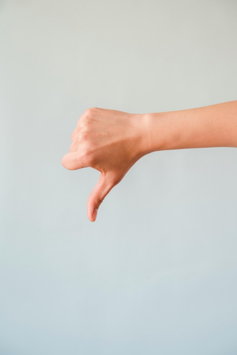 photograph of someone holding out their hand with a thumb down to signify Indiana's low ratings among green states in a recent Wallethub ranking of the 50 states